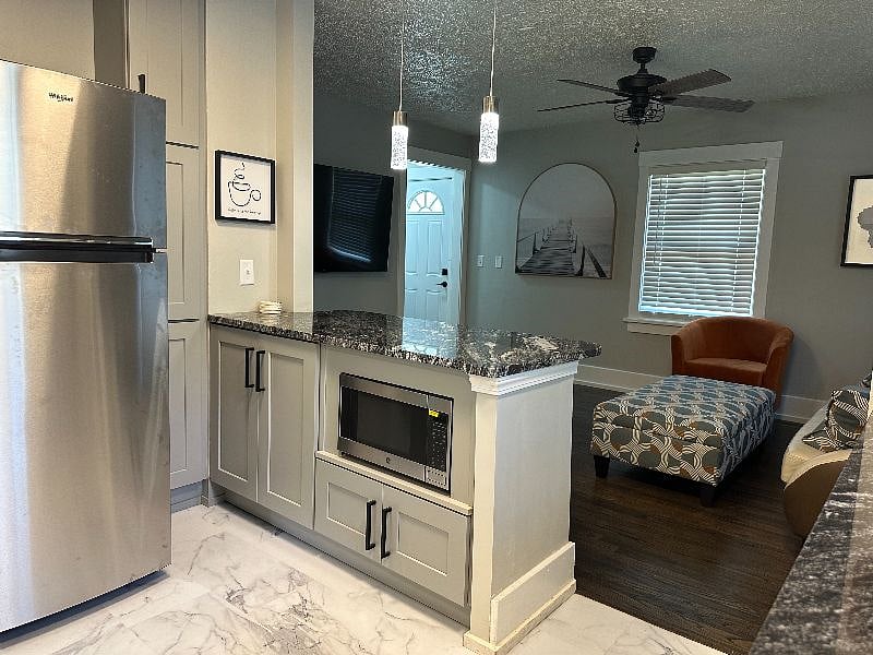 Talk to your guests in the living room while you are in the kitchen. It's a friendly environment to entertain.