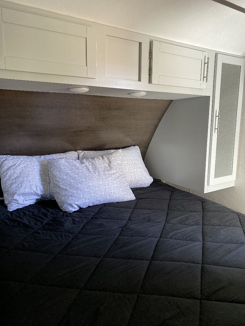 First bedroom with queen bed and closet storage