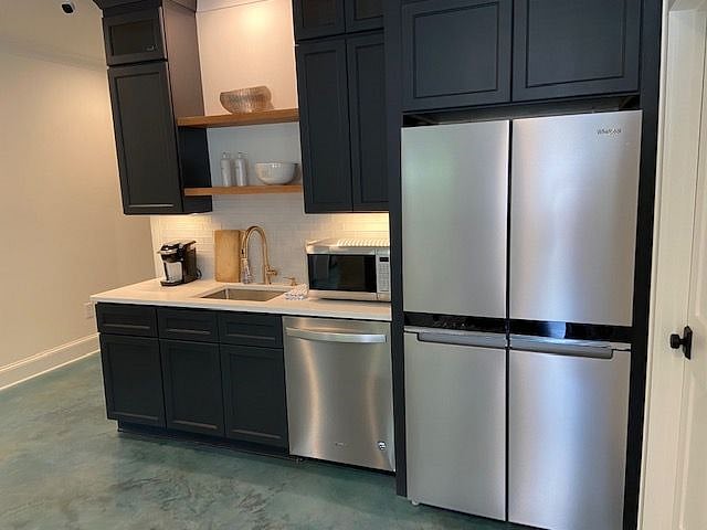 Full size refrigerator with ice maker, dishwasher, disposal, microwave/oven, combo, two burner hot plate can be plugged in. Utility room and storage in closet not shown.