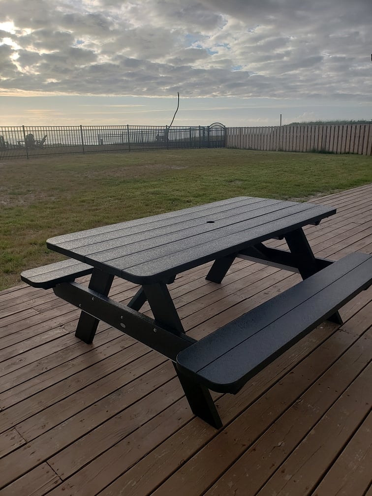 Polywood picnic table for six on backyard deck. Shade umbrella stored in Tuff Shed with portable bbq grill.