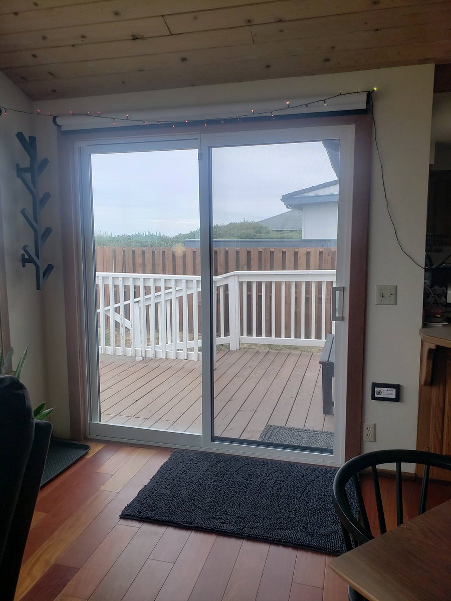 Sliding Glass Door directly out to deck, fenced in dog area, and beach access.