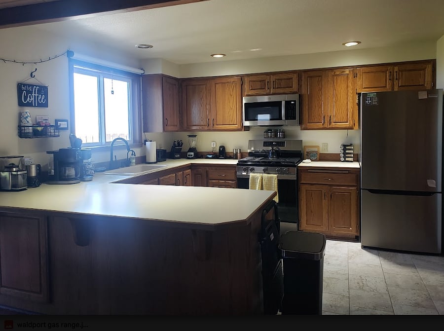New gas range and new refrigerator with water and ice dispenser.