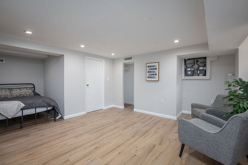 Partially finished basement includes a full sized bed.