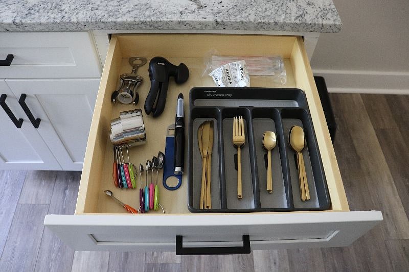 Measuring cups, kitchen shears, can opener, and wine opener.