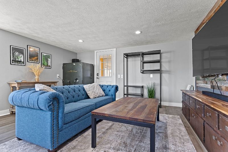 Living room with 65 inch swivel smart TV.