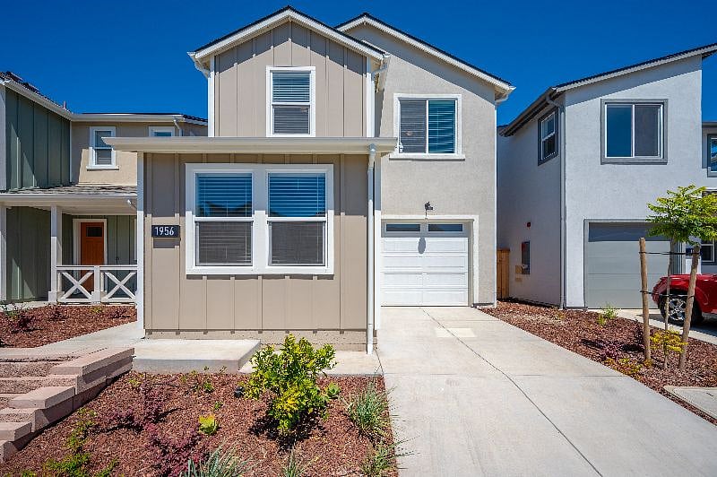 One car garage with some storage and driveway parking.