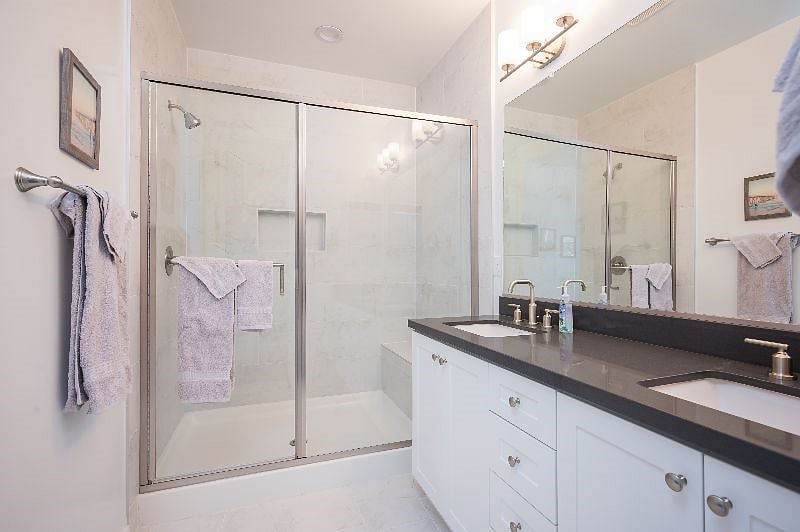 Primary suite's double sinks and large shower