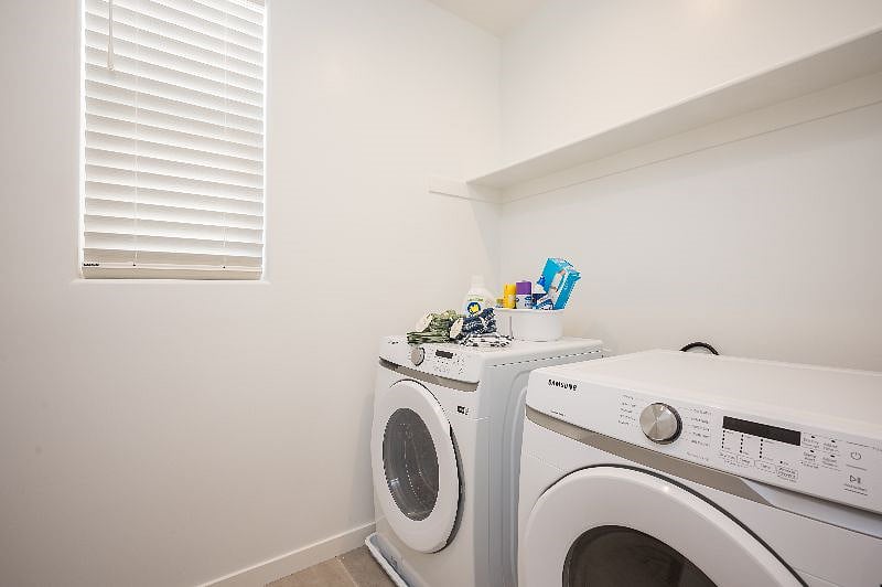 Laundry room with washer, dryer and sink on the other side