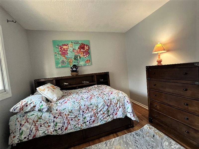 Twin Bedroom with storage drawers and dresser. Closet