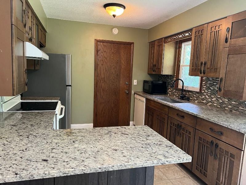 Fully furnished kitchen with Electric range, full size refrigerator and dishwasher.