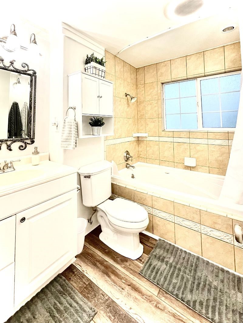 Full bathroom with beautifully tiled large bathtub/shower
