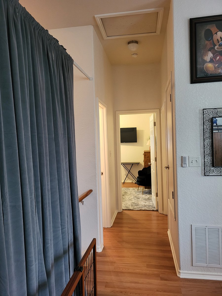 curtains on stairway for privacy, hallway leading to bathroom and bedroom
