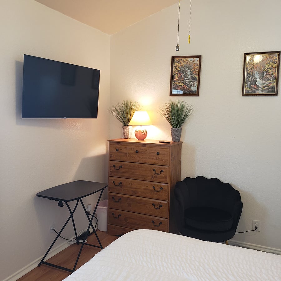smart TV, tall dresser, comfy chair