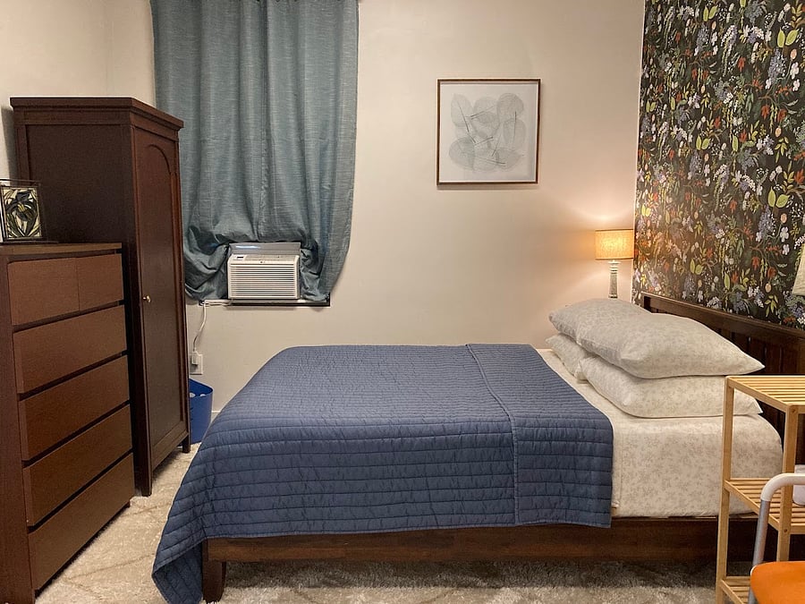 Queen bed with dense foam mattress and 100% cotton bedding.