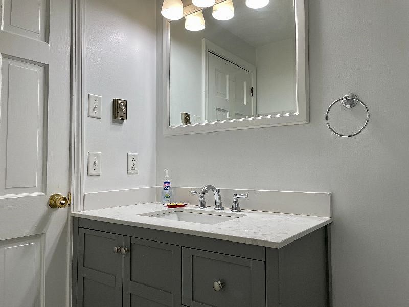 Vanity has small area for toiletries. There is more space in the hallway linen closet.