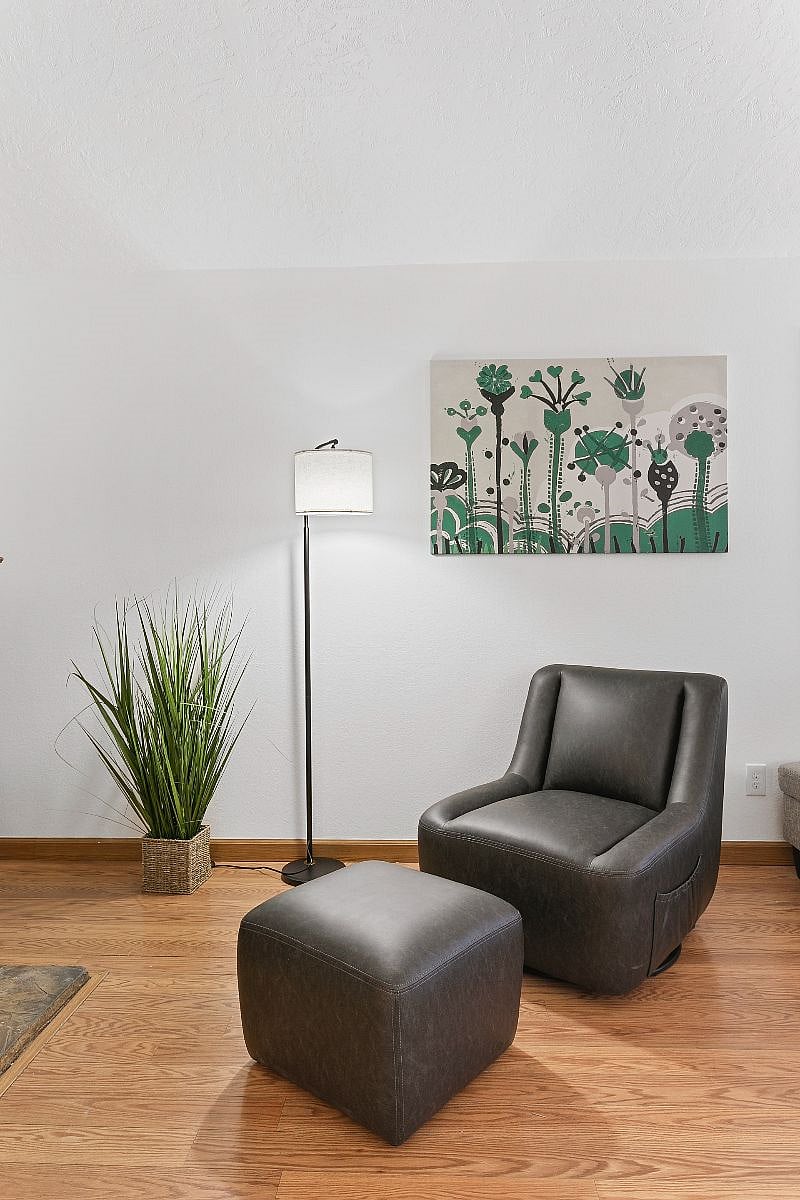 Leather swivel chair provides a comfortable spot to watch TV or read your favorite book. 