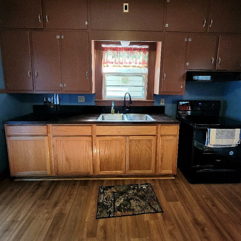 Kitchen: Electric range, hood, oven.