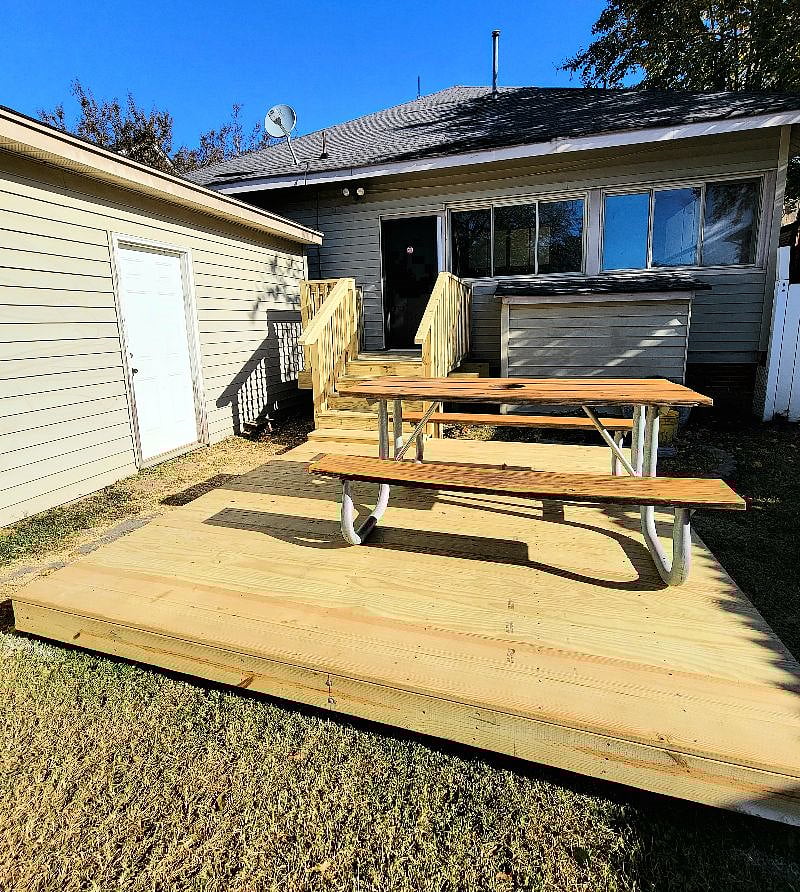 Fenced in back yard with picnic table