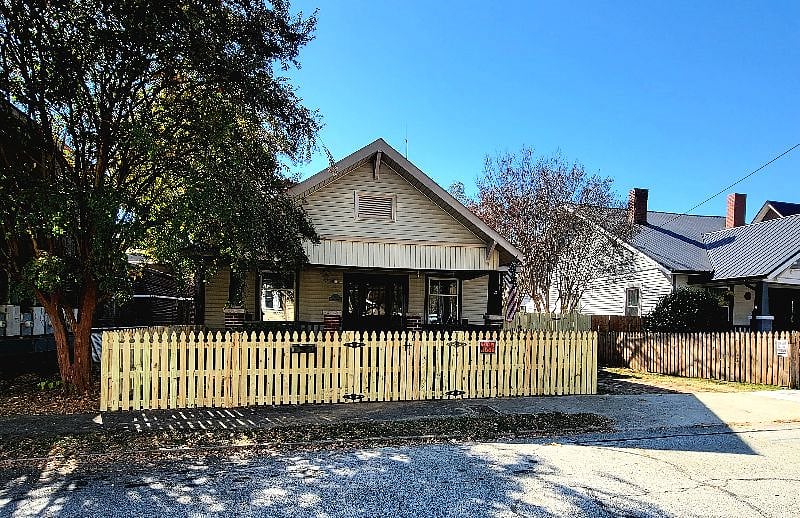 Front porch with picket fence and driveway