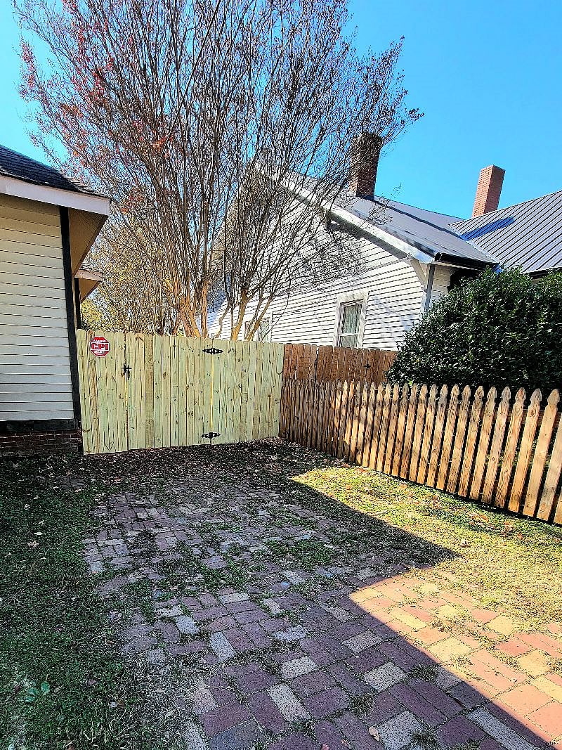Front of house: driveway and privacy fencing