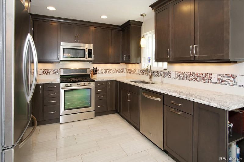 Spacious kitchen with plenty of dishware, utensils and appliances