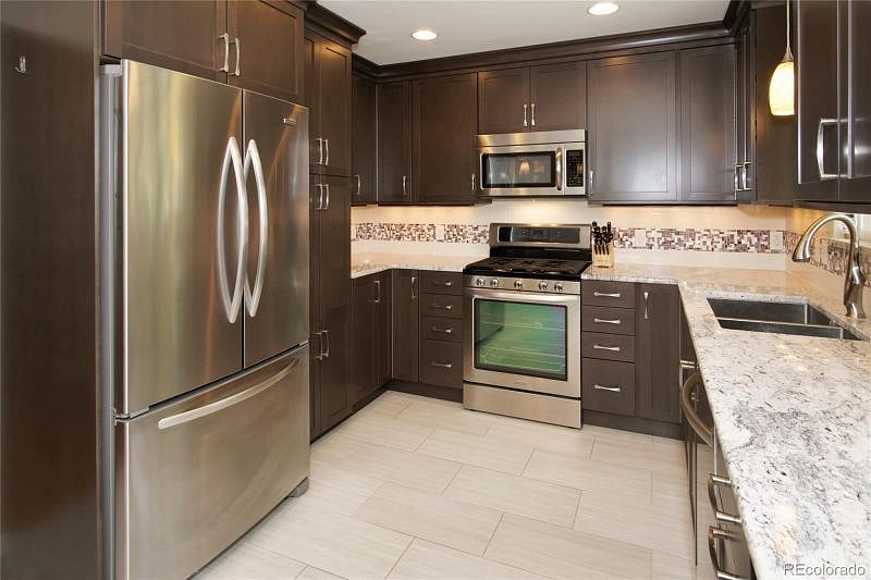 Spacious kitchen with plenty of dishware, utensils and appliances