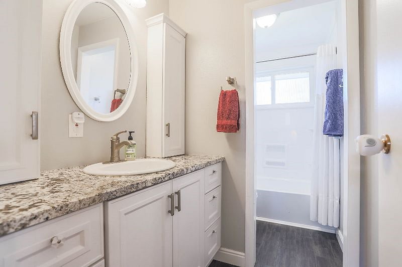 Main floor full bathroom with tub and shower