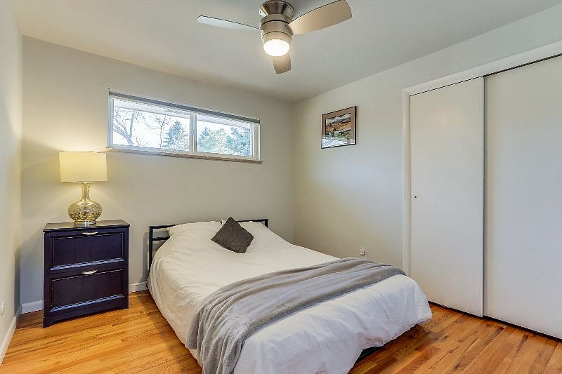 Main floor bedroom with queen bed, across from main floor full bathroom.