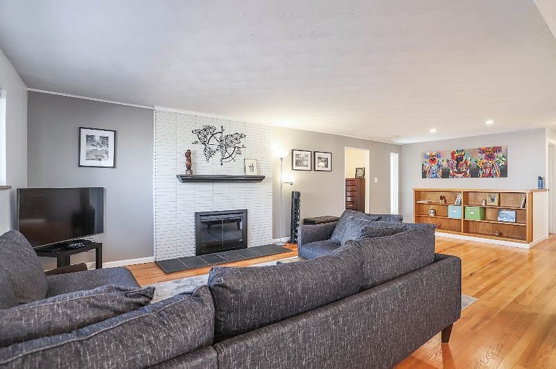Comfortable main floor living room and TV, enter from main entry and garage entryway.