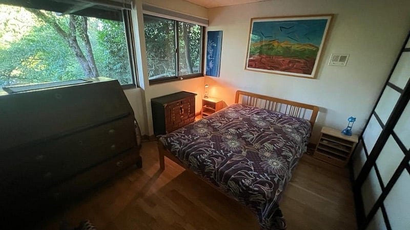 Bedroom 1. Full bed, wall to wall closet and drawers for storage, view to the garden