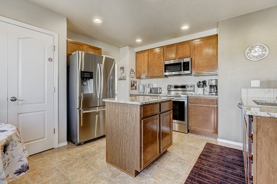 This modern kitchen with granite countertops & an abundance of cookware & utensils ensures that guests have everything they need for preparing meals. Pots, pans, baking sheets, & a complete set of utensils are neatly organized & easily accessible.