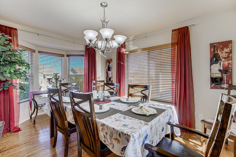 Large windows throughout the dining & living rooms allow an abundance of natural light to filter in. The play of sunlight on the gleaming hardwood floors creates a radiant atmosphere, making the entire space feel airy & bright (Dining table seats 8)