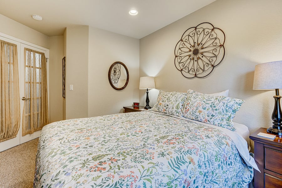 Experience comfort and convenience in our beautifully furnished main level bedroom. Enjoy ample storage with a large dresser and matching nightstands. For those who love to read, a bookcase filled with a variety of books awaits your discovery.