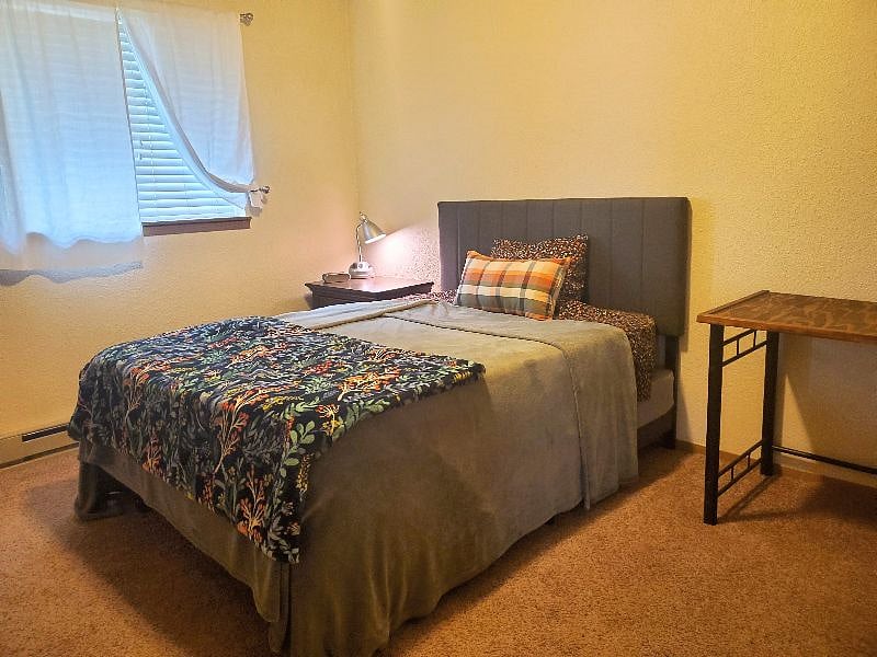 Bedroom 2: Full size bed, work desk with chair, nightstand, and full size closet.