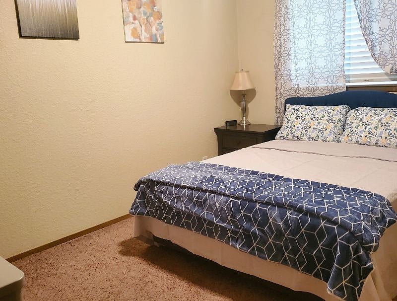 Bedroom 1: Queen bed, dresser, nightstand, television and full size closet.