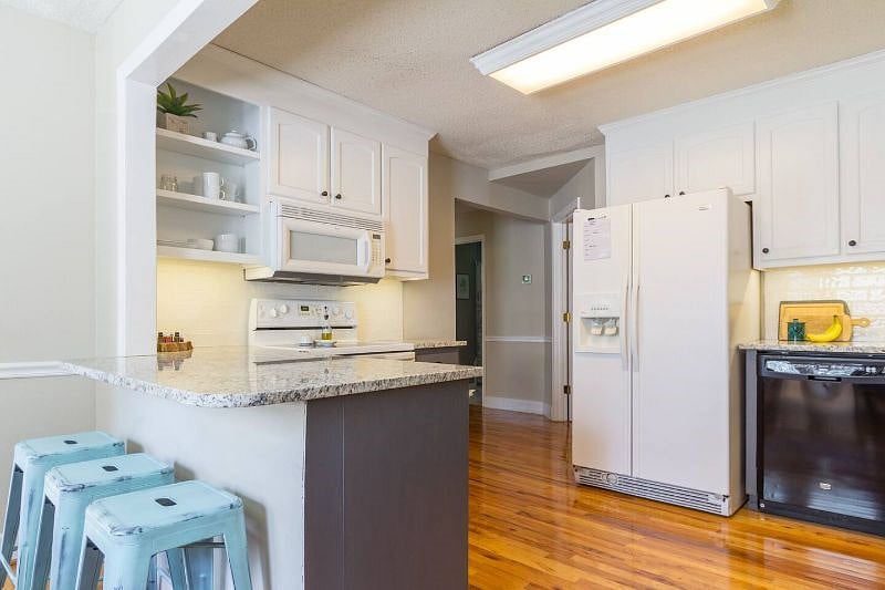 Wide view of our kitchen. Granite countertops with large space ready for cookie prep ;)