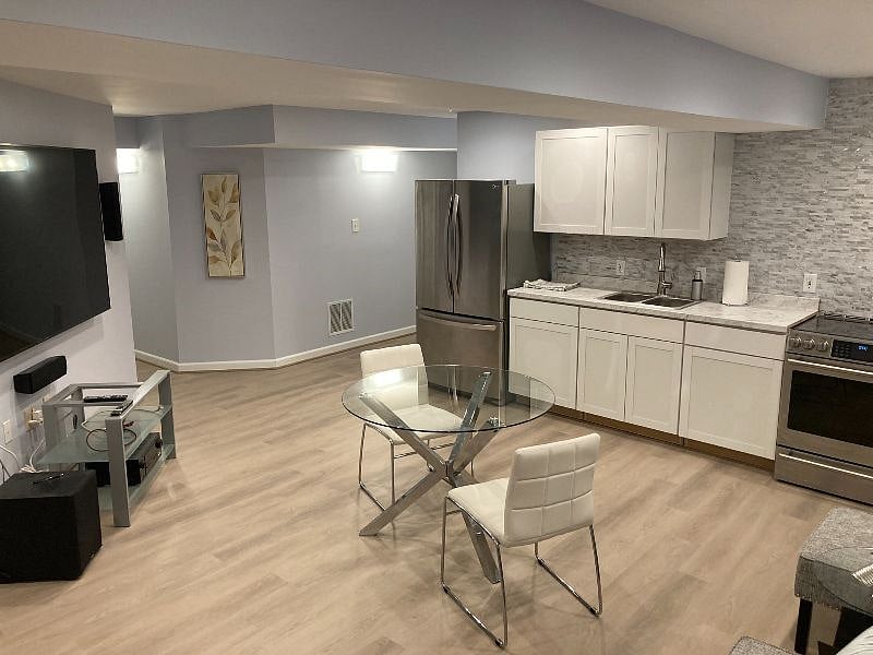 Kitchen with Bistro Table and separate sitting area while enjoying wall mounted 4K television.
