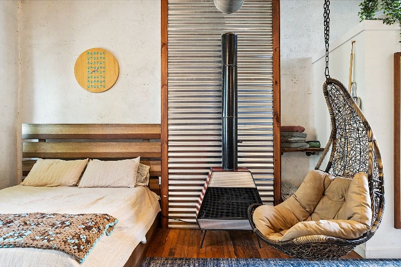 View of Queen Bed, Electric Fire Place, and Swing Chair
