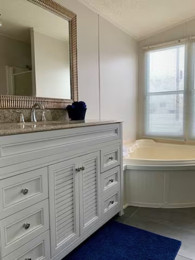 Ensuite bathroom off bedroom 1 with jacuzzi tub and shower