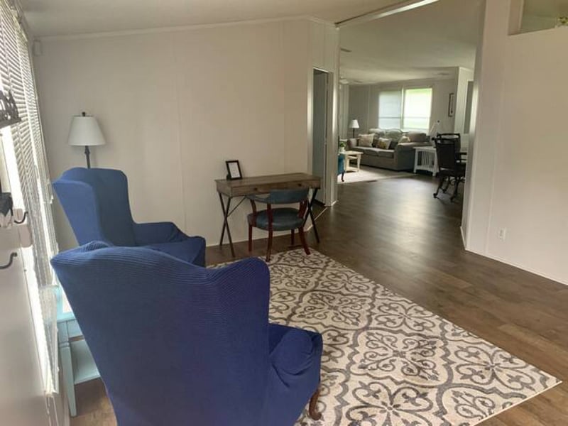 Front room with desk, desk chair, and 2 arm chairs
