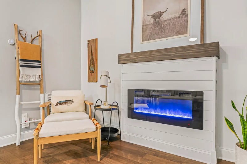 Living Room with lots of natural light, 75" smart TV, fireplace that can be used as a heat source or simply an ambiance. 