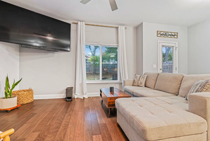 Living Room with lots of natural light, 75" smart TV, fireplace that can be used as a heat source or simply an ambiance. 