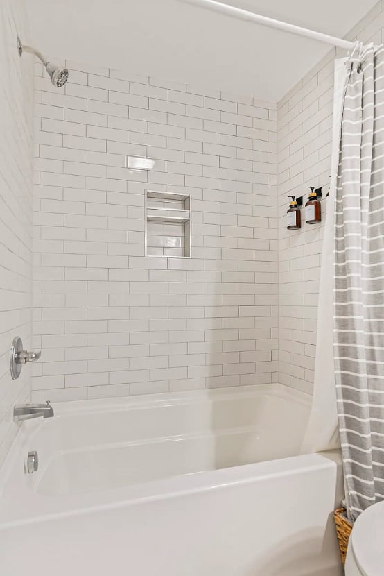 Second bathroom with full tub, shower and sink. 