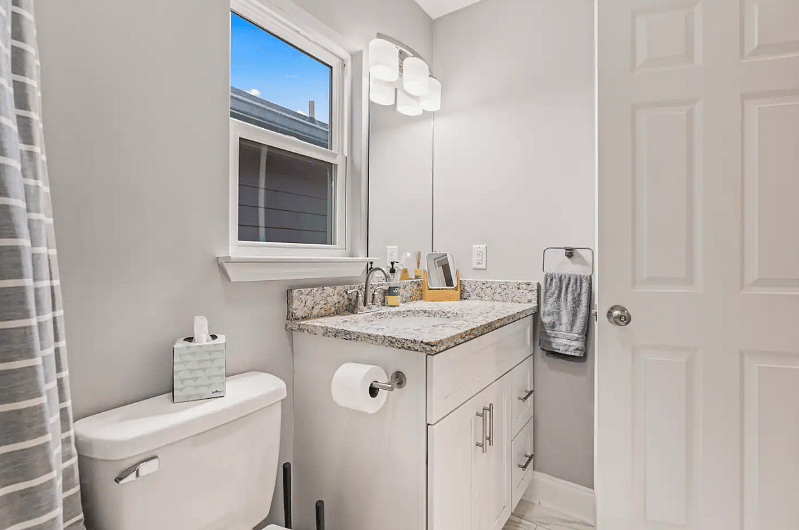 Second bathroom with full tub, shower and sink. 