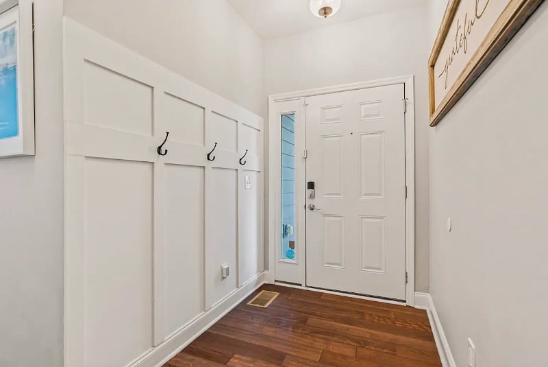 Entry Hallway with half bathroom for guest use. Hooks for jackets and the second entry door to the garage. 