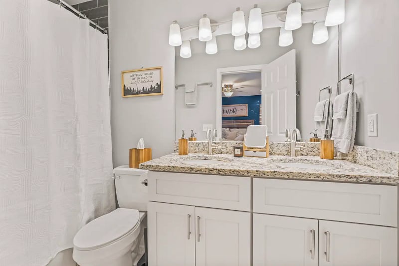 Master Bedroom equipped with 55" Smart TV, large walk in closet, a bathroom with shower, tub and his and her sinks. 