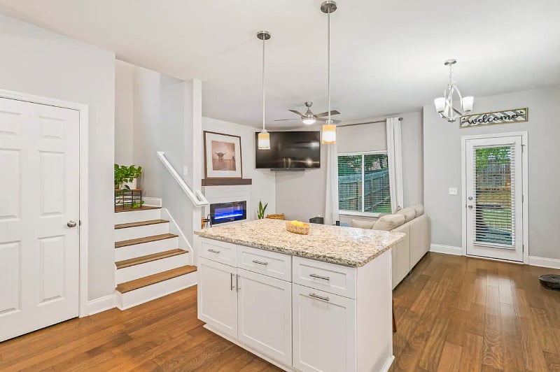 Living Room with lots of natural light, 75" smart TV, fireplace that can be used as a heat source or simply an ambiance. 