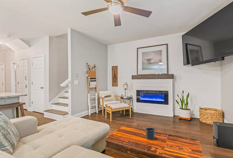 Living Room with lots of natural light, 75" smart TV, fireplace that can be used as a heat source or simply an ambiance. 