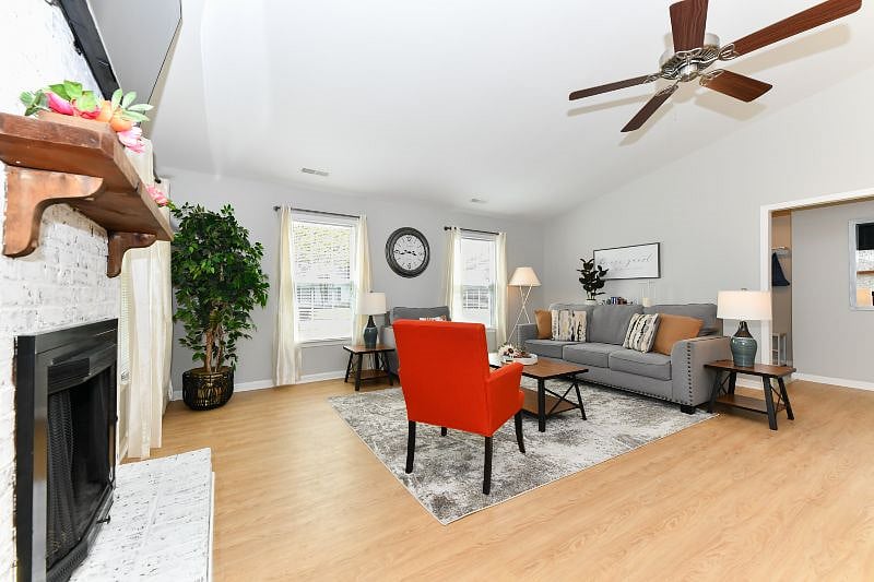 Open space living room with comfortable couches, smart TV, board games, books and pilllows