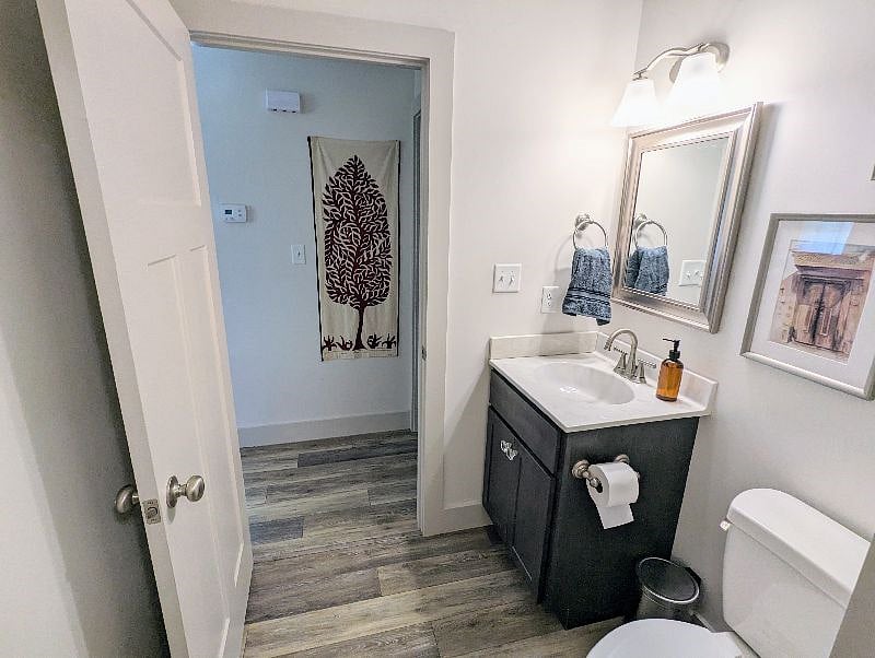 The home has three bathrooms. This is the guest bathroom located off the living room. It also connects to the laundry room.